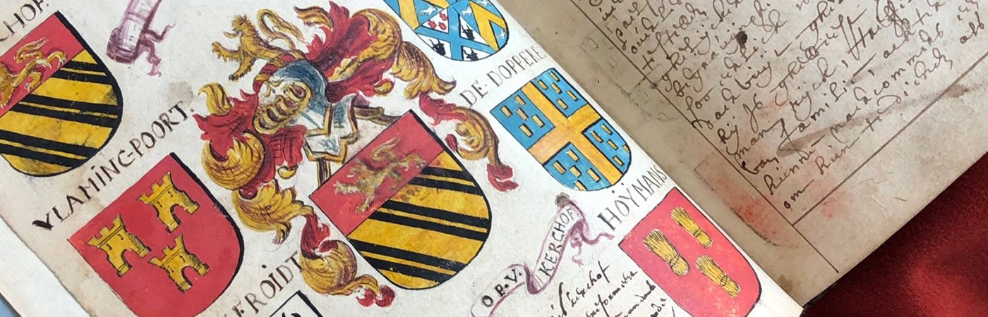 Photo of an open manuscript, with colorful images of crests on one page and writing on the other